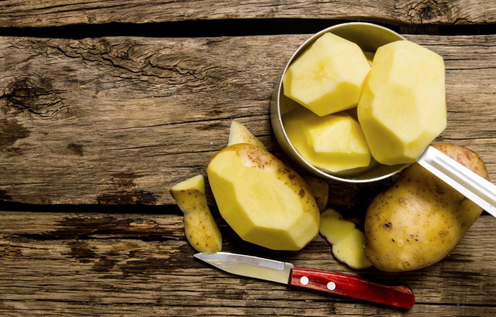 Peeled Potatoes In An Old Pan With Knife On Wooden Table . Free